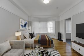 San Francisco apartment for rent - A modern bedroom with a large bed and a television.