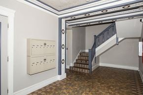 San Francisco apartment for rent - A staircase with a blue railing and a brown tiled floor.