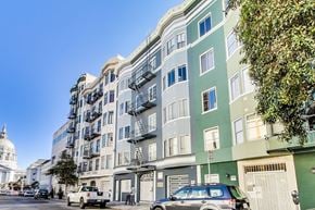 San Francisco apartment for rent - A street view of a city with cars and buildings.