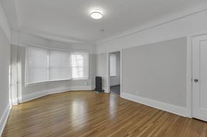 San Francisco apartment for rent - A room with wooden floors and white walls.