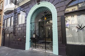 San Francisco apartment for rent - A black building with a turquoise arched doorway.