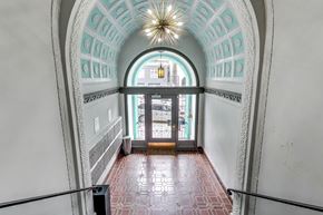 San Francisco apartment for rent - A hallway with a red tiled floor and white walls.