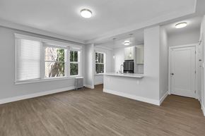 San Francisco apartment for rent - A spacious room with wooden flooring and white walls.