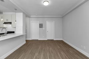 San Francisco apartment for rent - A spacious room with wooden flooring and white walls.