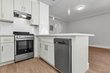 San Francisco apartment for rent - A modern kitchen with a stainless steel dishwasher and white cabinets.