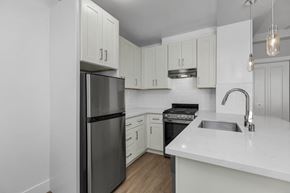 San Francisco apartment for rent - A modern kitchen with a stainless steel refrigerator and white countertops.