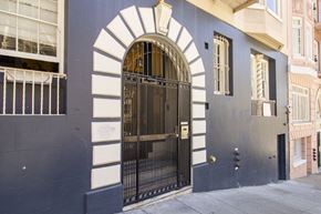 San Francisco apartment for rent - A black gate with a gold handle is in the middle of a white arch.