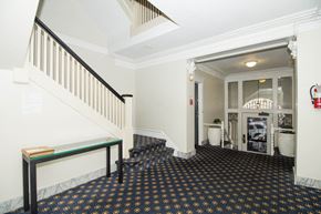 San Francisco apartment for rent - A hallway with a black and gold floor and white walls.