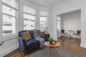San Francisco apartment for rent - A living room with a blue couch and a wooden coffee table.