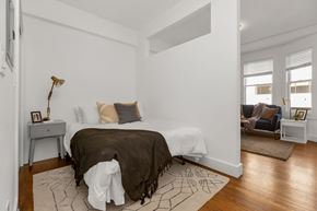 San Francisco apartment for rent - A bedroom with a bed, a chair, and a table.