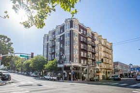 San Francisco apartment for rent - A sunny day in the city with a street view of a multi-story building.