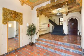 San Francisco apartment for rent - A staircase with a wooden handrail and a plant on the side.