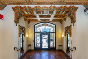 San Francisco apartment for rent - A hallway with a black door and a red light on the wall.