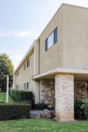 Tustin apartment for rent - A house with a stone pillar in front of it.