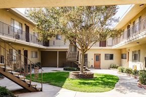 Whittier apartment for rent - A courtyard with a tree and a staircase.