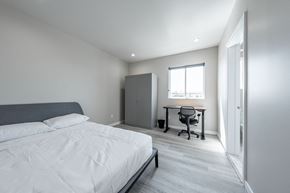 Los Angeles apartment for rent - a bedroom with a bed and a desk and a window