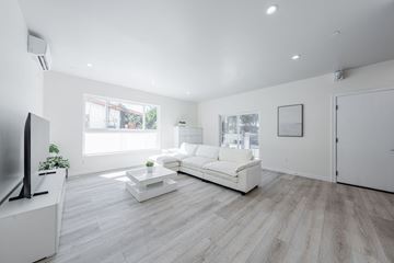 Los Angeles apartment for rent - a living room with a white couch and a tv