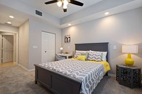 Boyton Beach apartment for rent - A bedroom with a large bed and a ceiling fan.
