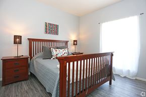 Chandler apartment for rent - A bedroom with a bed, nightstand, and lamp.