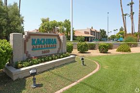 Chandler apartment for rent - A sign for Kachina Apartments is in front of a building and palm trees.