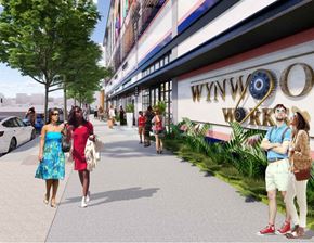 Miami apartment for rent - A group of people are walking down a sidewalk past a store with the name Wynwood on it.