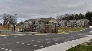 Hendersonville apartment for rent - an empty parking lot in front of a row of houses