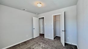 Angleton house for rent - a bedroom with a carpeted floor and a door to a closet