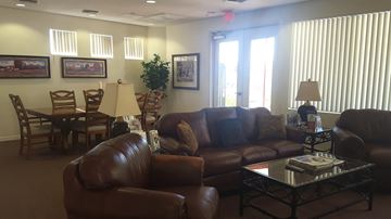 Phoenix apartment for rent - a living room with couches and chairs and a dining room table