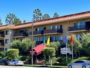Torrance apartment for rent - a building with flags in front of it on a street