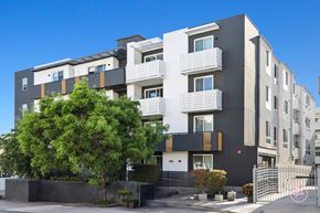 Los Angeles apartment for rent - A modern apartment building with a mix of black, white, and beige colors.