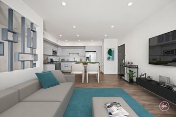 Los Angeles apartment for rent - A modern living room with a grey sofa and a blue rug.