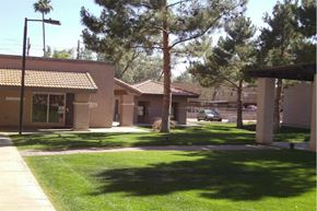 Phoenix apartment for rent - a building with a lawn and trees in front of it