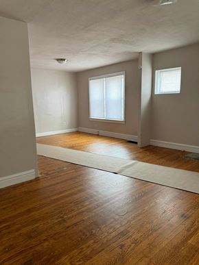 Saint Louis apartment for rent - an empty living room with wood floors and a window