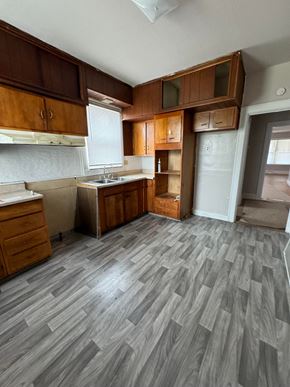 Saint Louis apartment for rent - an empty kitchen with wooden floors and wooden cabinets