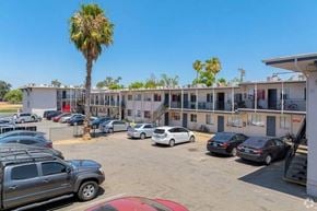 Sacramento apartment for rent - A parking lot with several cars and a building in the background.
