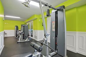 Windsor Mill townhouse for rent - A gym with a row of exercise machines.