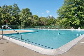 Windsor Mill townhouse for rent - A large outdoor swimming pool surrounded by a green fence.