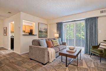 Windsor Mill townhouse for rent - A living room with a couch, chair, and a painting on the wall.
