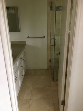 Santa Barbara house for rent - A bathroom with a glass shower door and a white counter.
