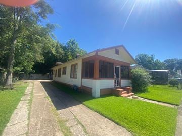 Prichard house for rent - a small white house with a driveway and a lawn