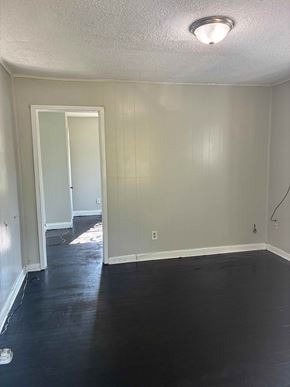 Prichard house for rent - A room with a doorway leading to another room.