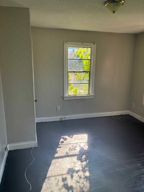 Prichard house for rent - A room with a window and a wooden floor.
