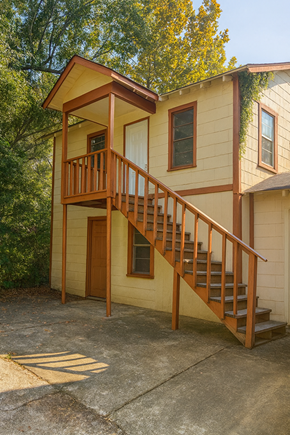 Prichard house for rent - A small house with a balcony and stairs.