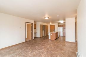 Dickinson apartment for rent - an empty living room and kitchen with a tile floor