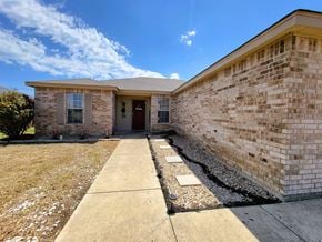Killeen house for rent - the front of a brick house with a sidewalk and grass