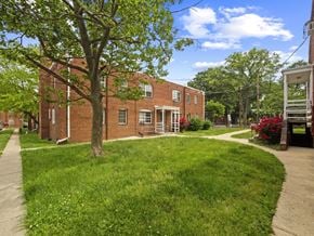 Washington apartment for rent - A tree in front of a brick building.