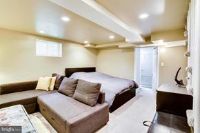 Washington house for rent - A bedroom with a bed, couch, and a window.