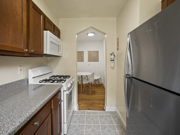 Washington apartment for rent - A kitchen with a stove, refrigerator, and cabinets.