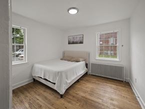 Washington apartment for rent - A bedroom with a bed, a window, and a picture on the wall.