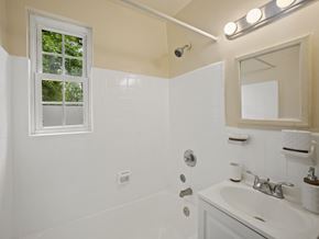 Washington apartment for rent - A white bathroom with a window and a sink.